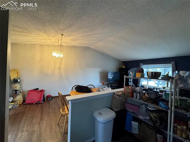 a living room with furniture a flat screen tv and gym equipment