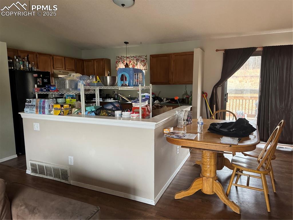 2135 Westmoreland Road Colorado Springs, CO 80907 - Photo 5 of 8 a view of a dining room with furniture and a window