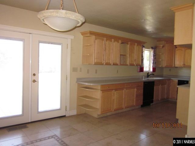 1945 California Avenue Reno, NV 89509 - Photo 4 of 12 a kitchen with granite countertop white cabinets and white appliances