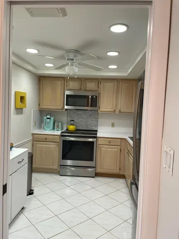 a kitchen with a sink stainless steel appliances and cabinets