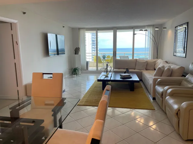a living room with furniture and large windows
