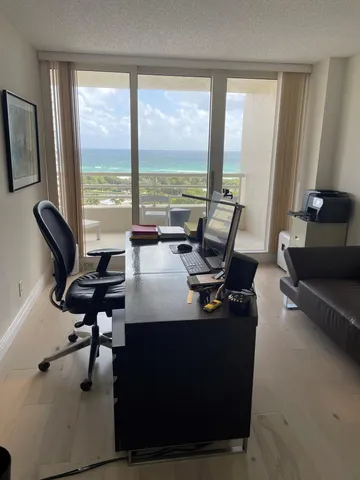a living room with furniture and floor to ceiling window