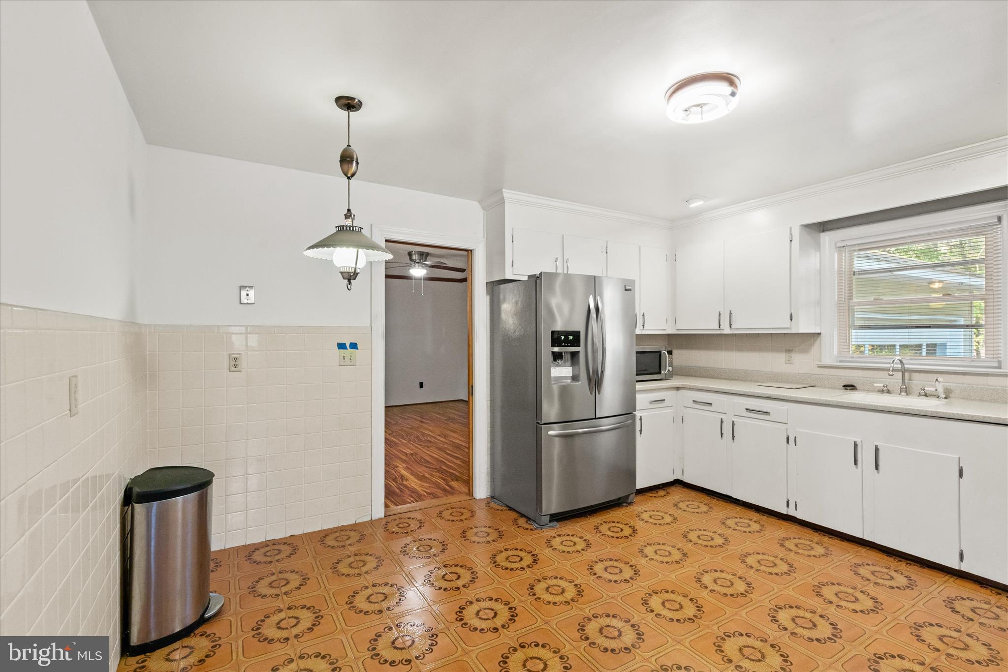 625 Pine Bluff Road Salisbury, MD 21801 - Photo 15 of 37 a kitchen with refrigerator cabinets and wooden floor