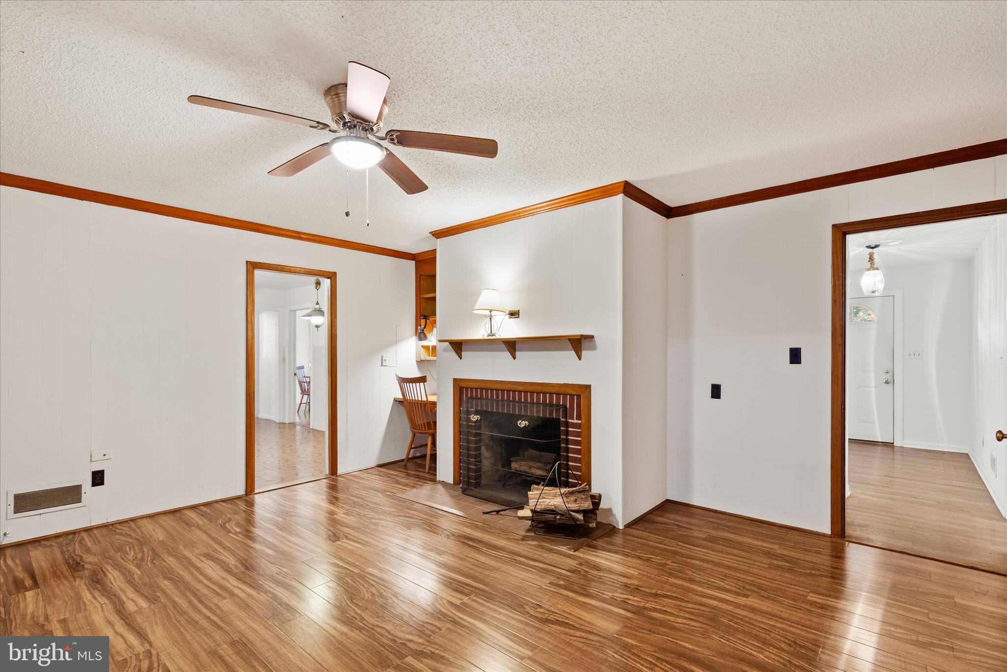 625 Pine Bluff Road Salisbury, MD 21801 - Photo 17 of 37 a view of an empty room with wooden floor a ceiling fan and a fireplace
