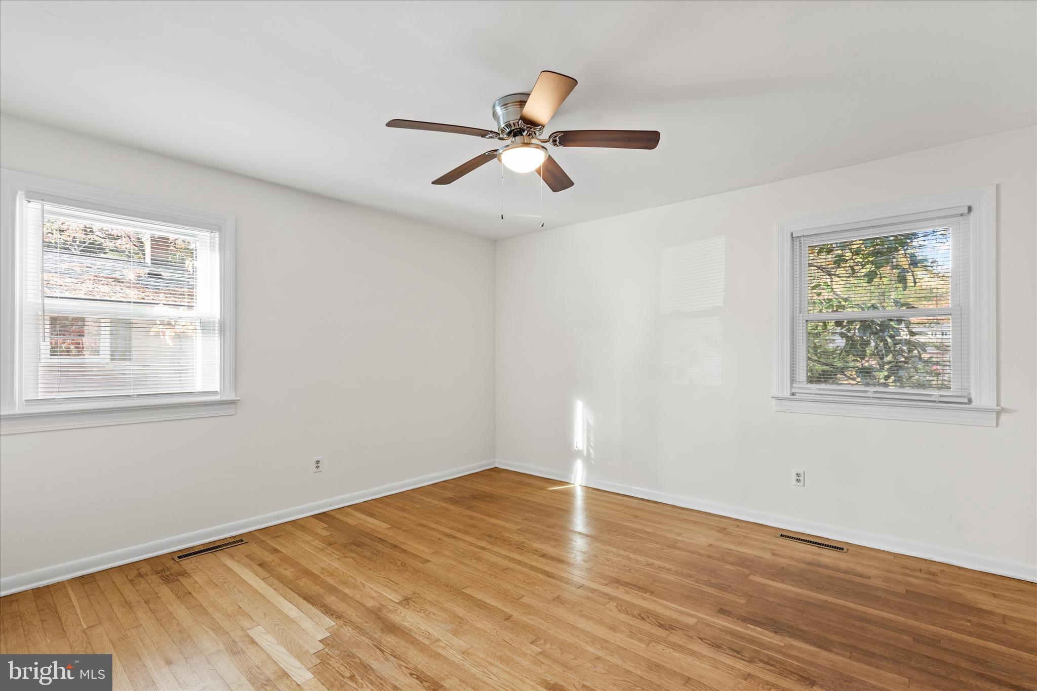 625 Pine Bluff Road Salisbury, MD 21801 - Photo 26 of 37 a view of empty room with wooden floor and fan