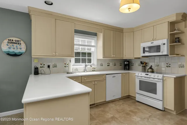 a kitchen with a sink cabinets and window