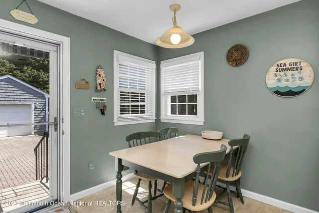 a view of a dining room with furniture and window