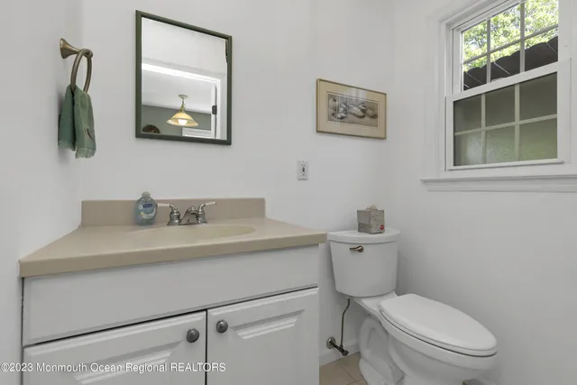 a bathroom with a toilet a sink and mirror