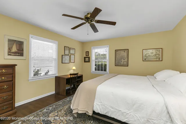 a bedroom with a bed dresser and a window