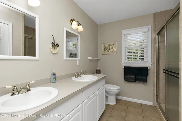 a bathroom with a sink a toilet a mirror and a tub