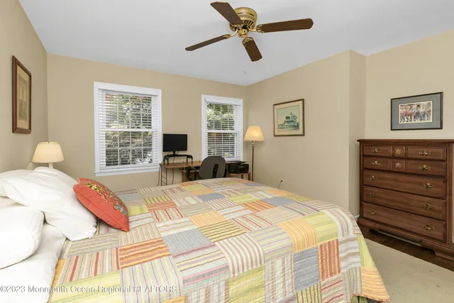 a bedroom with a bed a dresser and a window