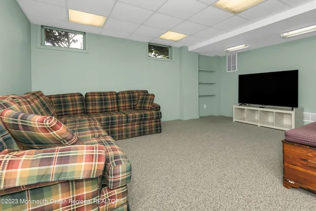 a living room with a flat screen tv and gym equipment