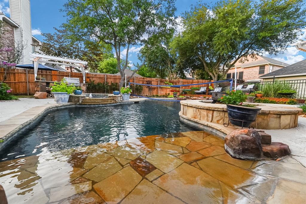 a view of a swimming pool with a patio and a fire pit