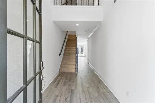 a view of entryway and hall with wooden floor