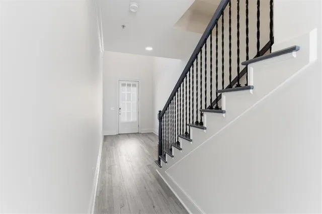 an entryway in a hallway with wooden floor