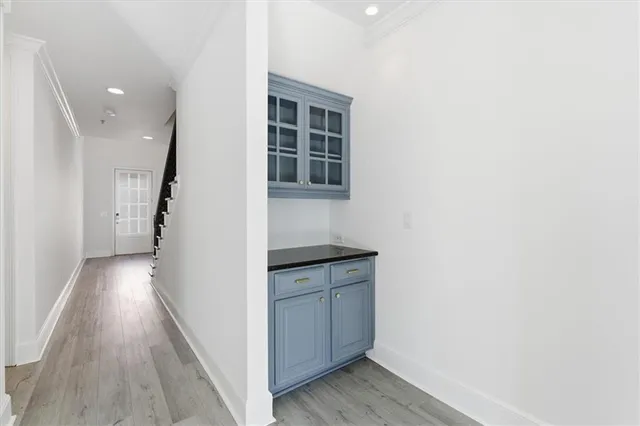 a hallway with cabinets and wooden floor