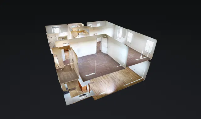 a view of a hallway with wooden floor and entryway