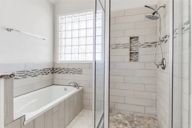 a bathroom with a bathtub and shower