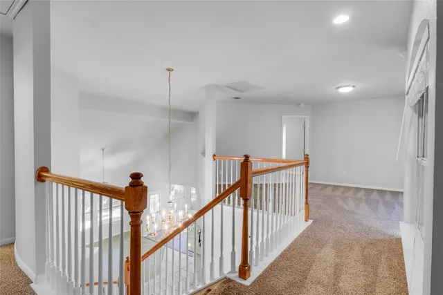 a view of a hallway with stairs