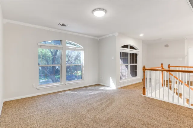 an empty room with wooden floor and mirror