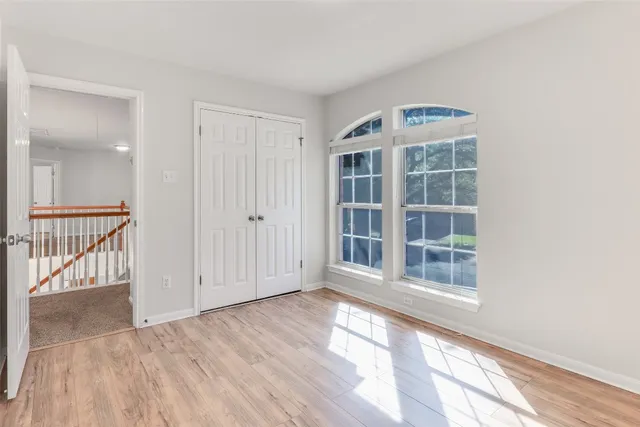 a view of a room with wooden floor