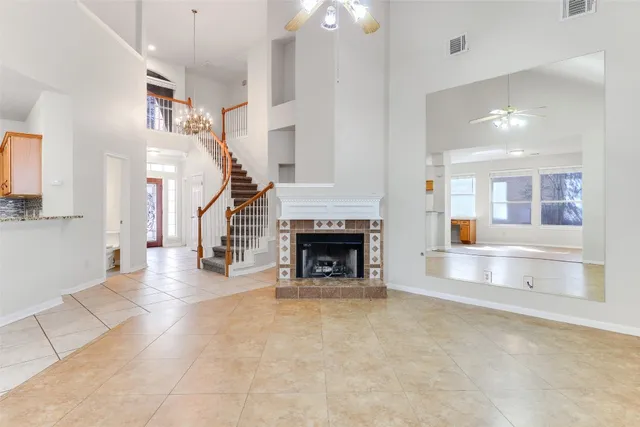 a view of a livingroom with fireplace and chandelier