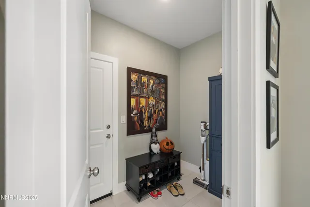 a bedroom with a bed a chandelier and a mirror on the dresser