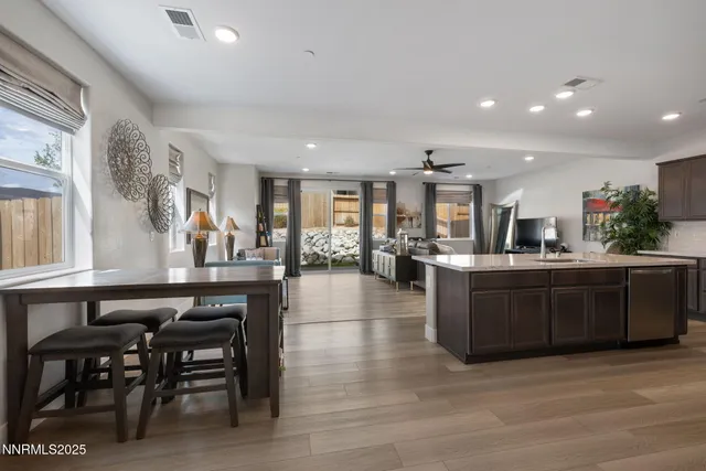 a white toilet sitting next to a white sink and vanity