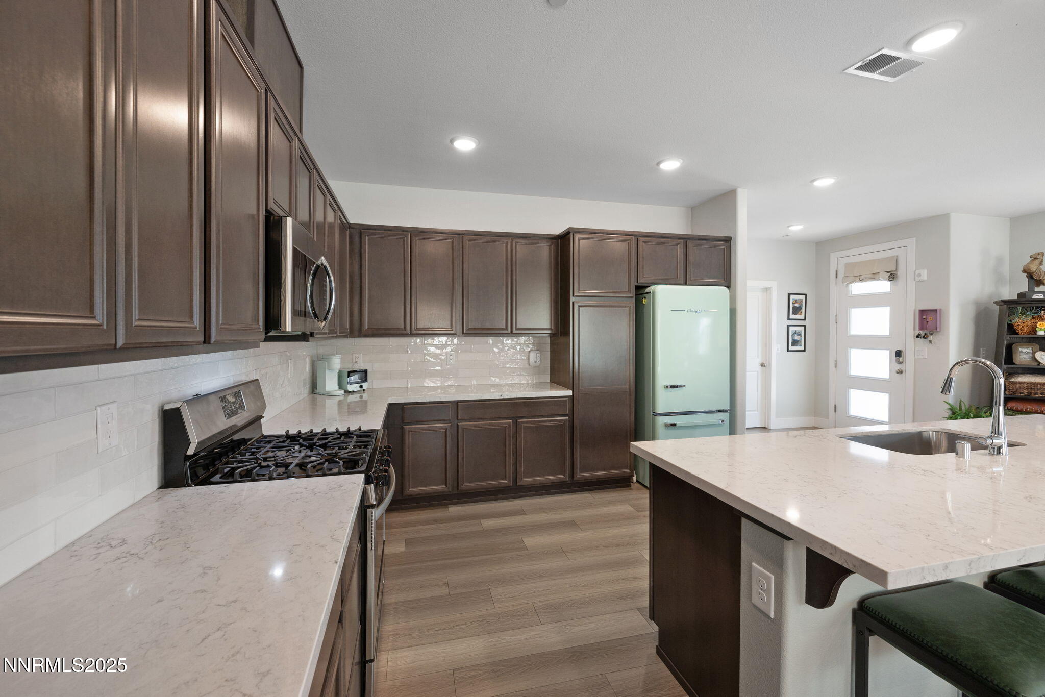 3604 Pulsar Lane, Unit 3 Carson City, NV 89705 - Photo 35 of 59 a kitchen with stainless steel appliances a sink a stove a refrigerator cabinets and chairs
