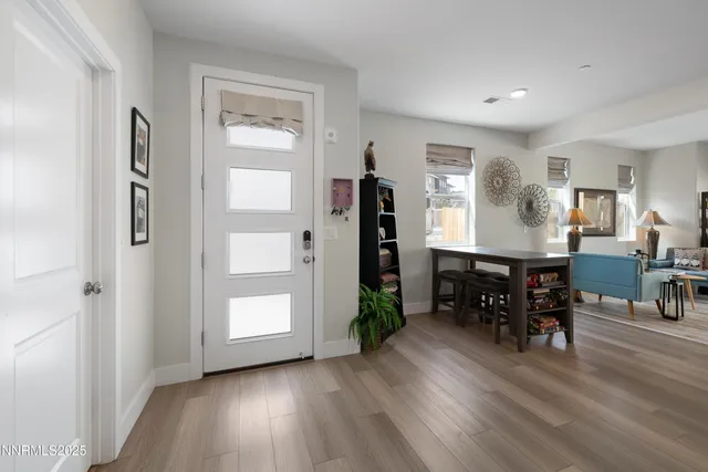 a living room with furniture flat screen tv and window