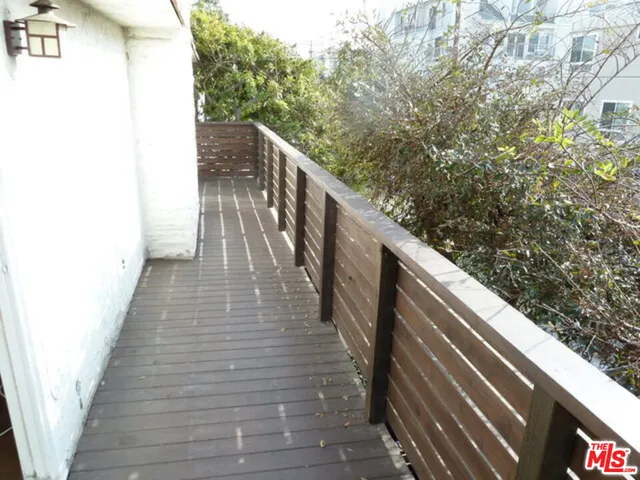 a balcony with wooden floor