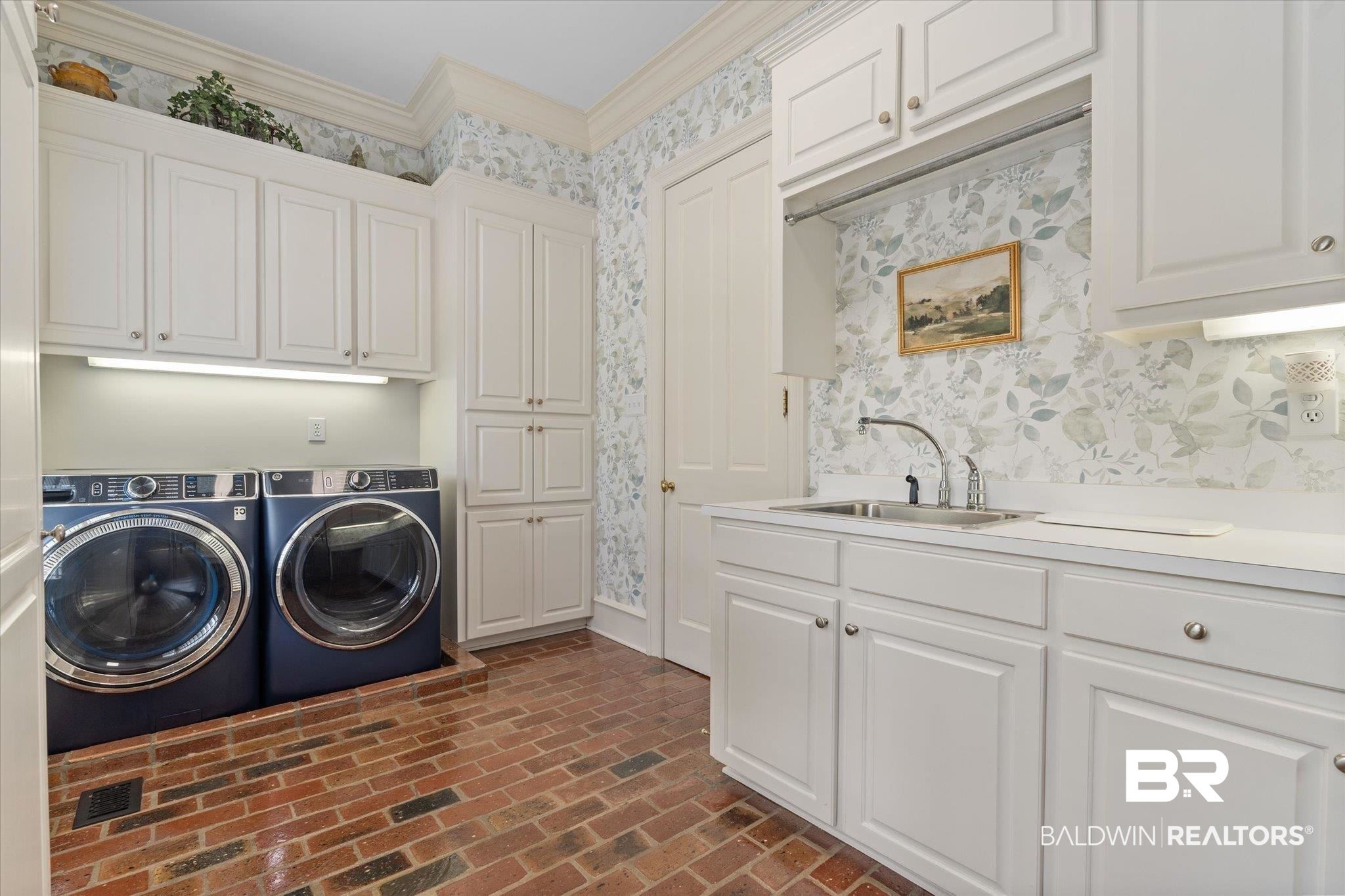8561 Dawes Lake Road Mobile, AL 36619 - Photo 22 of 63 Laundry room with wallpapered walls, washing machine and dryer, cabinet space, brick floors, and ornamental molding