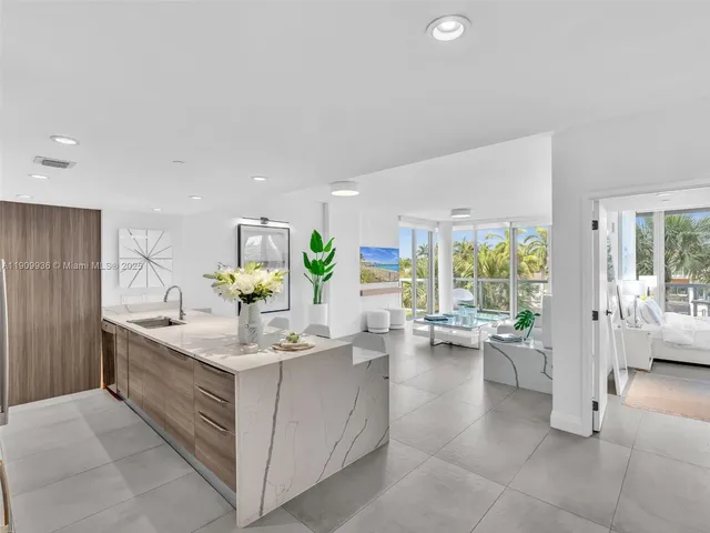 a view of living room with granite countertop furniture and floor to ceiling window