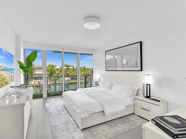 a bedroom with a bed and a potted plant