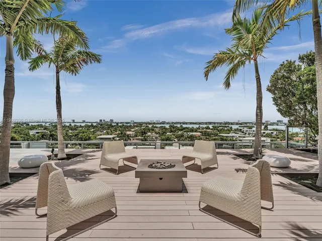a view of a roof deck with couches and potted plants