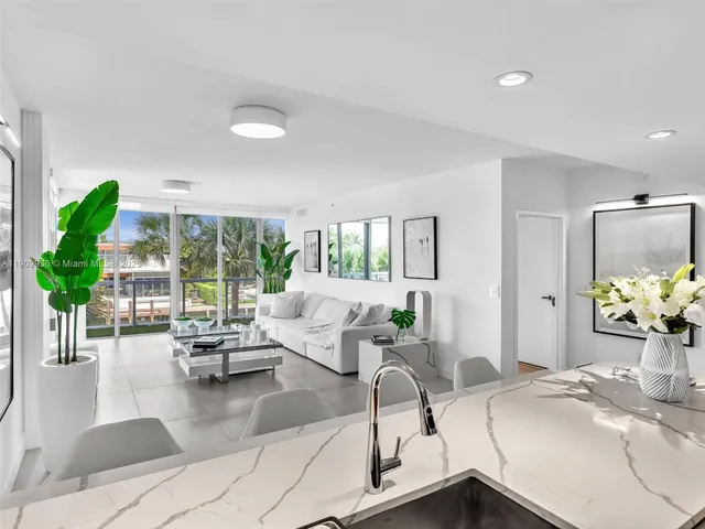 a living room with fireplace furniture and a potted plant