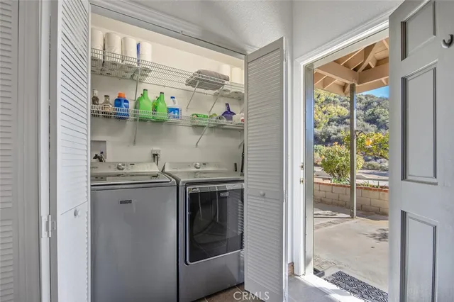 a view of a patio with a table and chairs