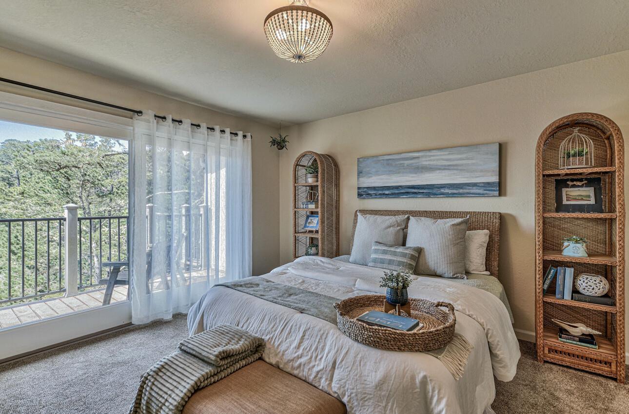250 Forest Ridge Road, Unit 64 Monterey, CA 93940 - Photo 17 of 35 a bedroom with a large bed and a window