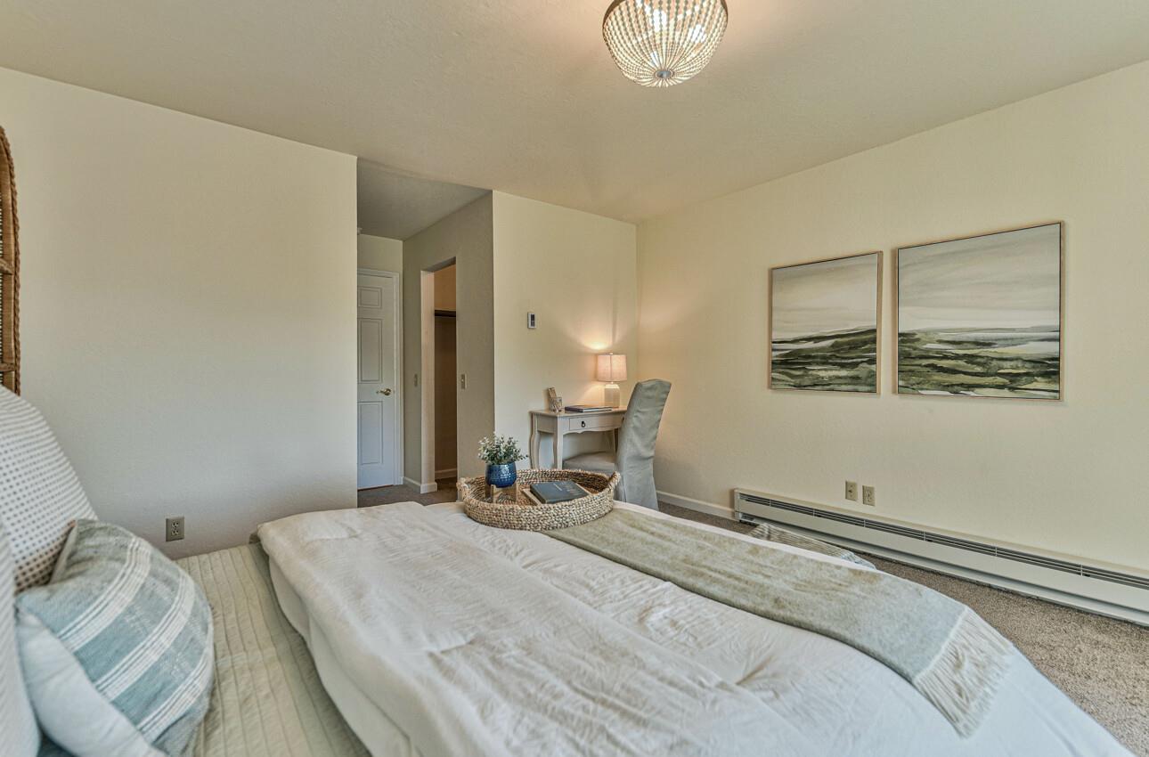 250 Forest Ridge Road, Unit 64 Monterey, CA 93940 - Photo 24 of 35 a bedroom with a bed and a painting on the wall