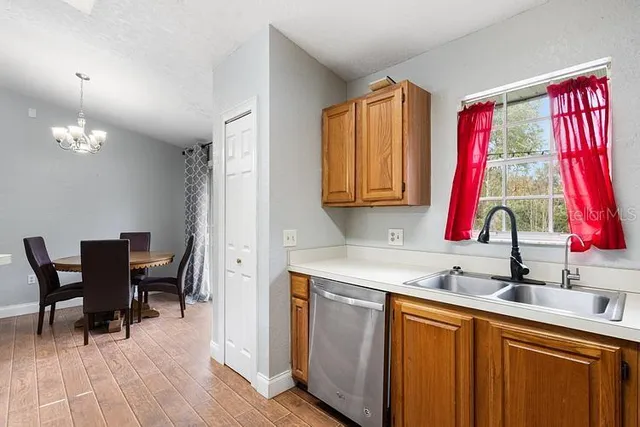 a kitchen with a sink a table and chairs