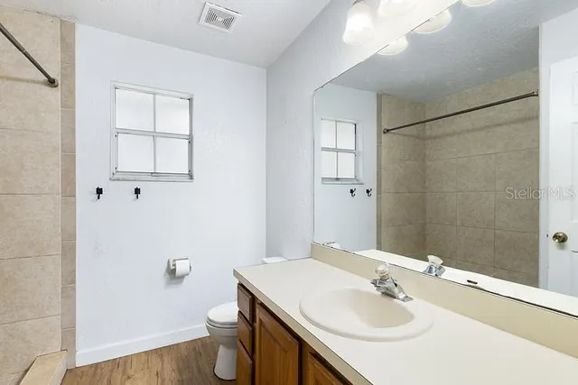 a bathroom with a sink toilet and vanity