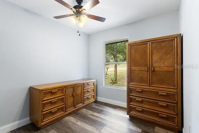 a view of room with stairs and a chandelier fan