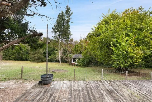 a view of a lake with a wooden deck