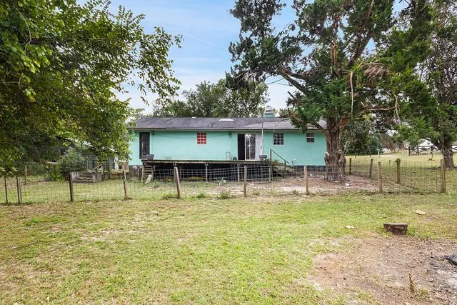 a view of a house with a yard porch and sitting area