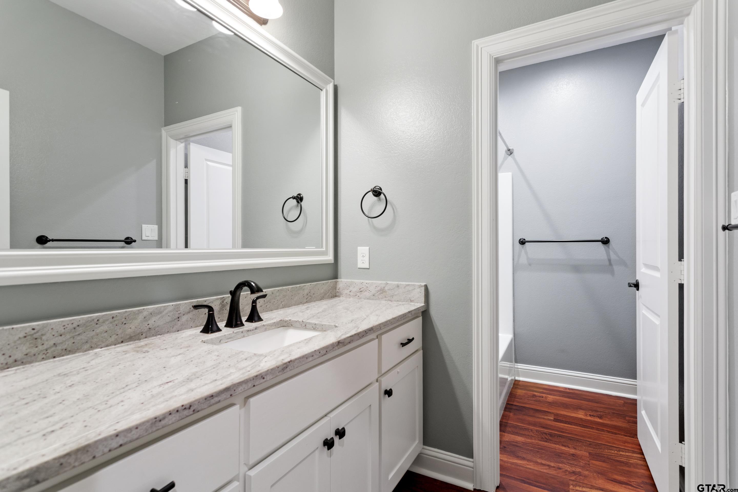 105 Nathan Road Chandler, TX 75758 - Photo 22 of 36 a bathroom with a sink and a mirror