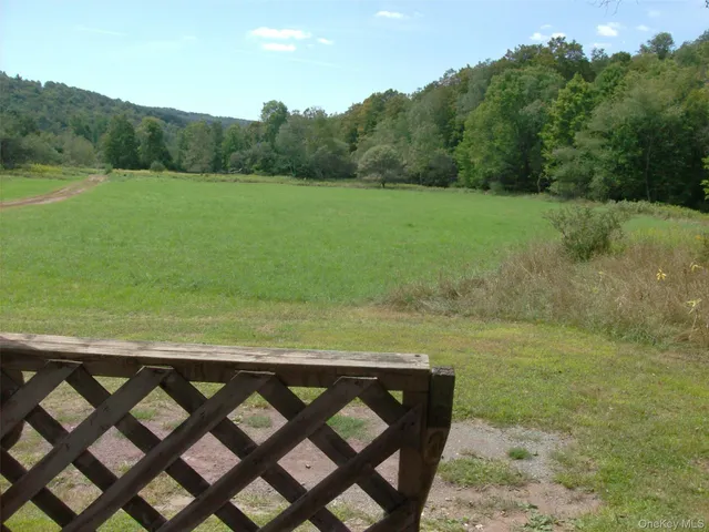a view of a yard with a table and chairs