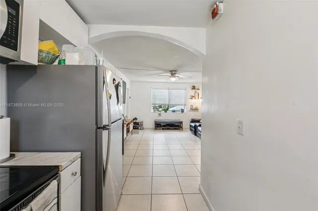 a kitchen with a refrigerator and a stove top oven