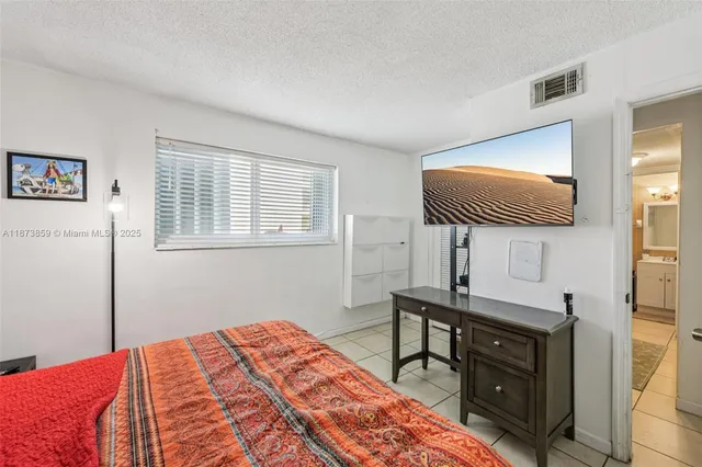 a bedroom with a bed and a table