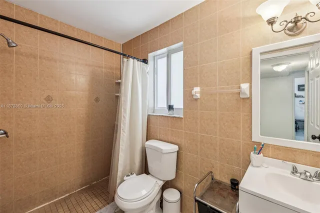 a white toilet sitting next to a bathroom sink