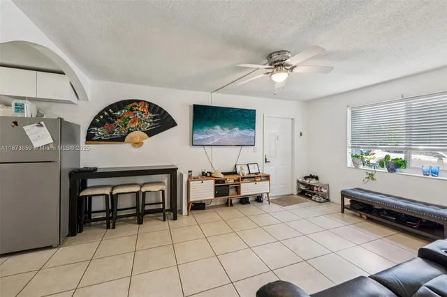 a living room with furniture a table and a chandelier